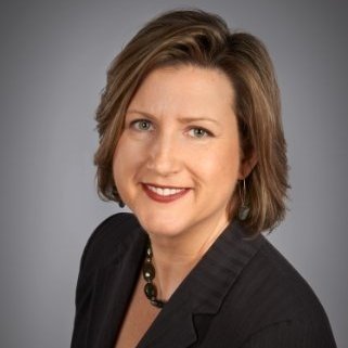 Headshot of caucasian woman in a black shirt with short brown hair