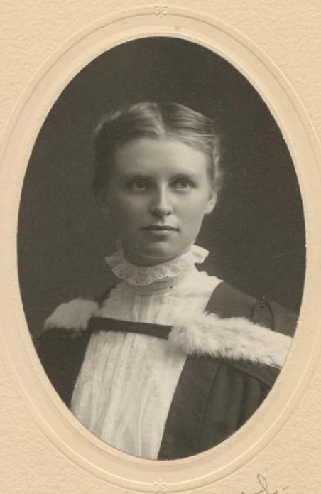 Black and white photo of a young Kate Rice in a graduation gown. Photo is framed by an oval frame.