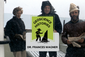 Three people standing on the deck of a boat with snow falling. Text on top of the photo reads: "Geoscience Histories, Frances Wagner"