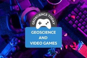 A desk with a keyboard, headphones, video game controller, toy and candy on it. On top of the photo text reads: Geoscience Today: Geoscience and Video Games.